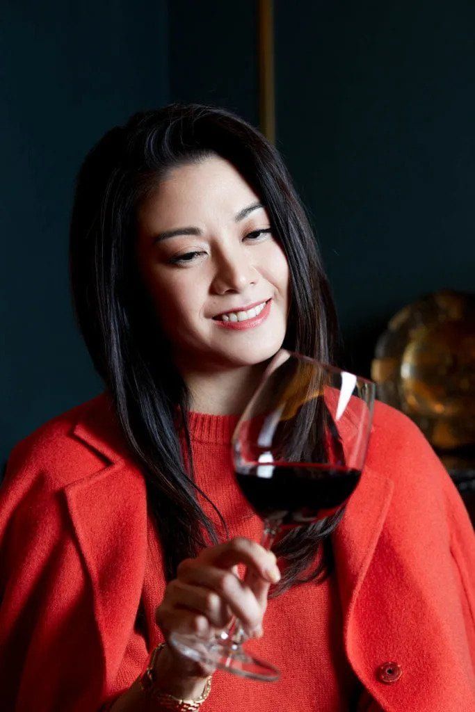 bernice liu holding glass of red wine